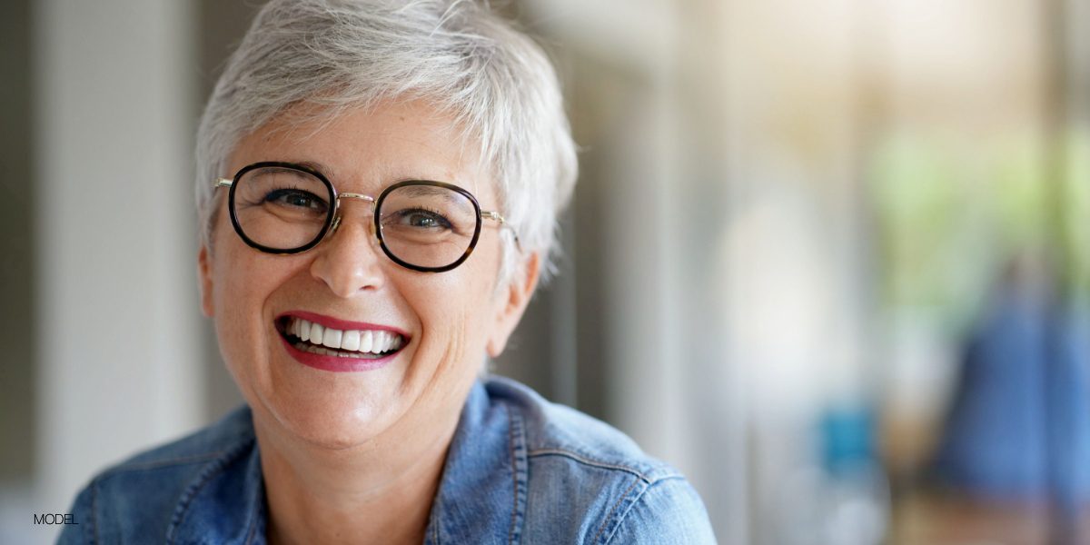 women with glasses smiling