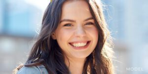 Smiling Teen Model Outside Building | Mercer Island Oral Maxillofacial Surgery Smiling teen model for wisdom teeth removal
